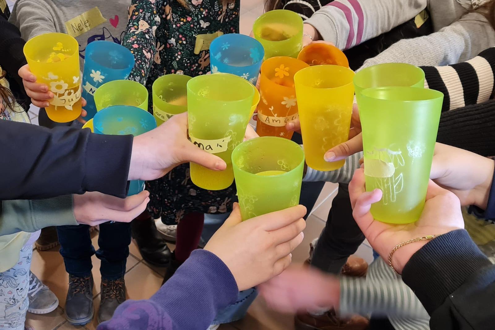 Hände Halten Bunte Becher in die Mitte